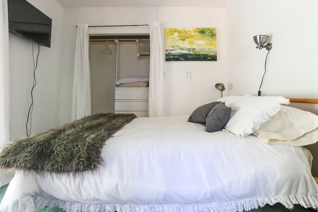 Comfy bed! Large closet to hang clothes and a dresser as well. Light over the bed for reading and a TV at the foot of the bed.