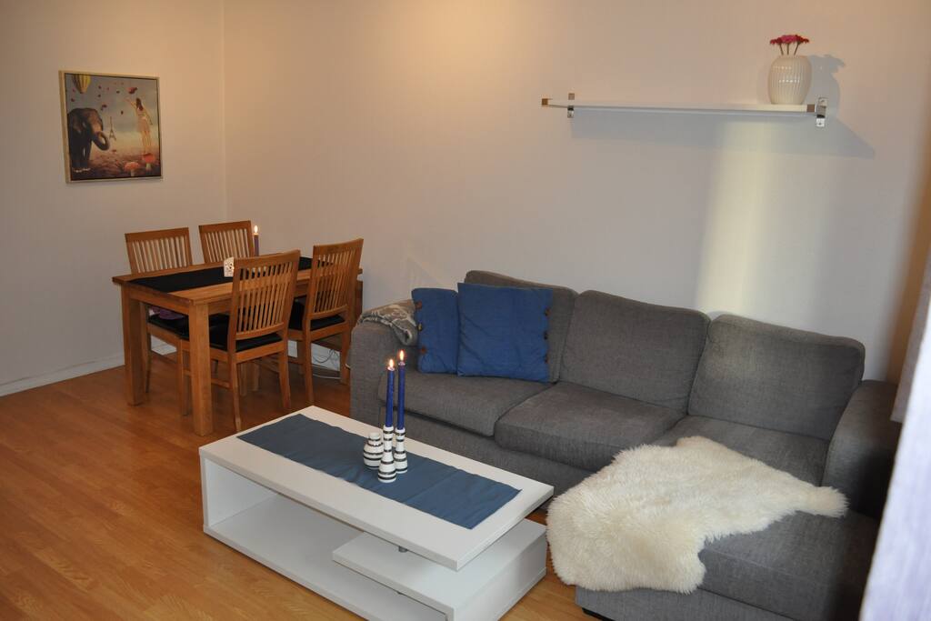 living room with sofa, dining table, tv and balcony
