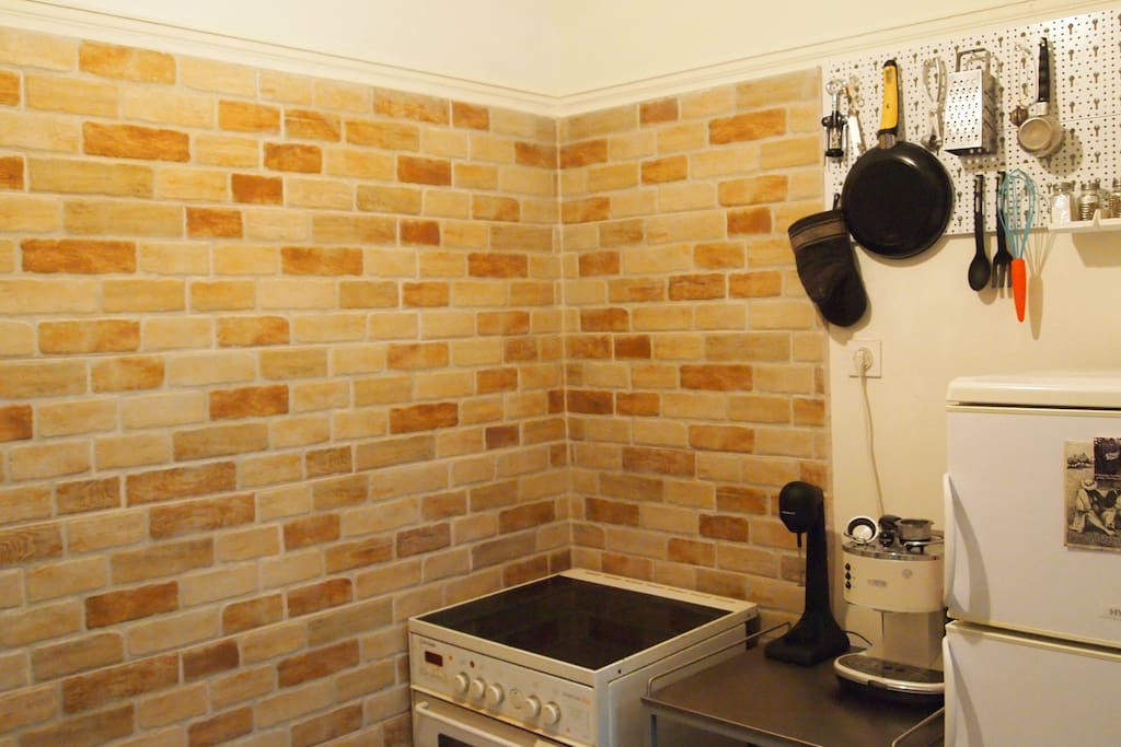 Kitchen at night. With stove/oven, coffee machines and fridge
