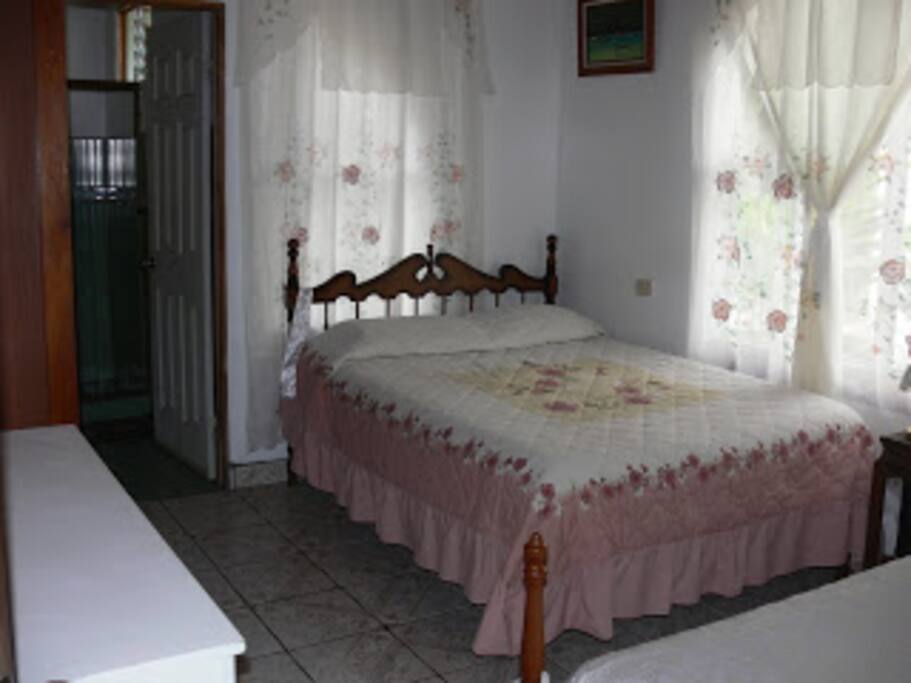 Private room II with one queen sized bed and one twin bed and bathroom.