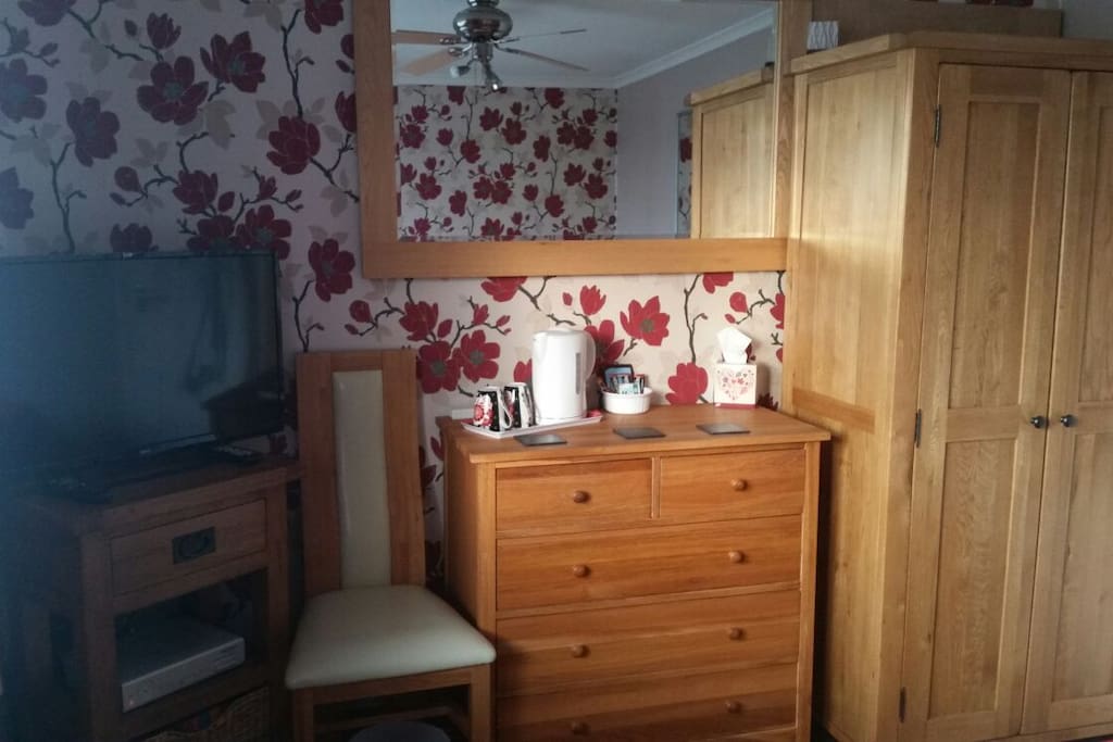 TV, tea/coffee, drawers and wardrobe.