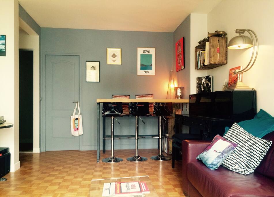 Living room, table and piano.