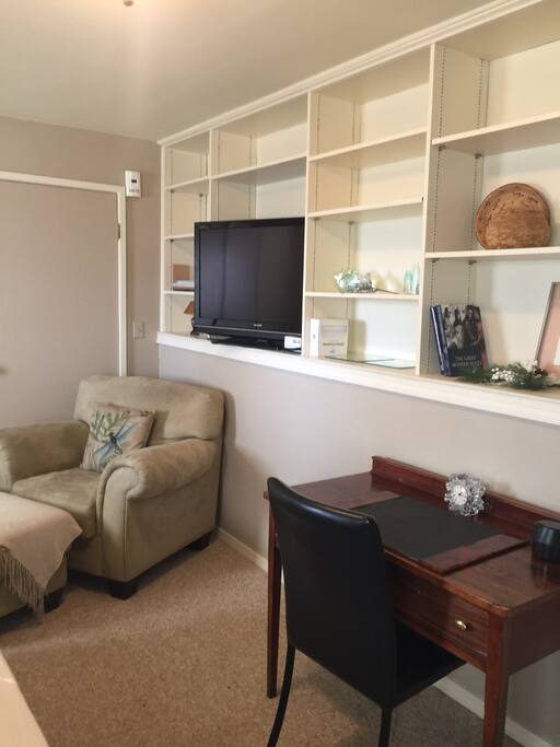 A comfy chair where you can read or work on your computer; desk and office amenities included.