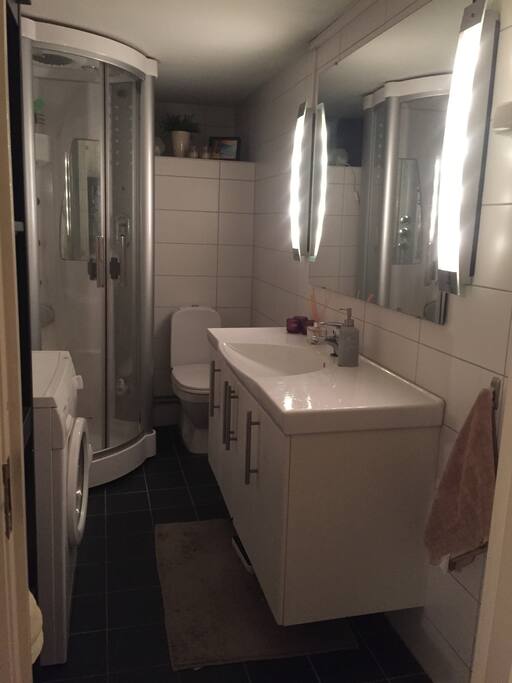 Bathroom with shower and washing machine