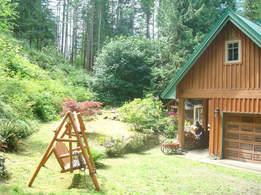 Back view with garden swing and play area.