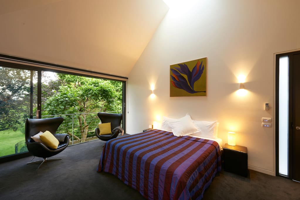 Origami inspired high ceilings with moon window to the stars above the bed