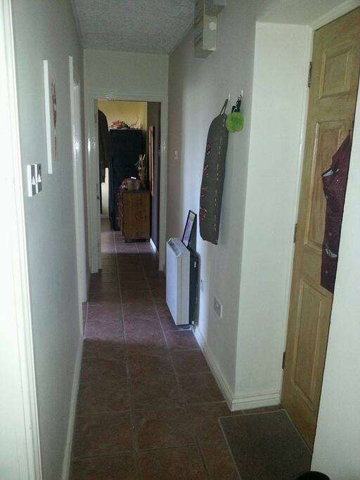 Corridor with main entrance and 2 bedroom entrances. The double bedroom is the one in front.