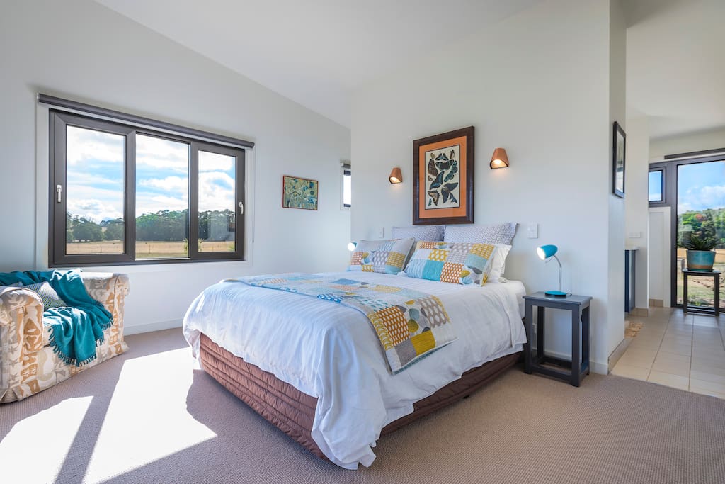 The main bedroom streams sunlight from windows on the east and north