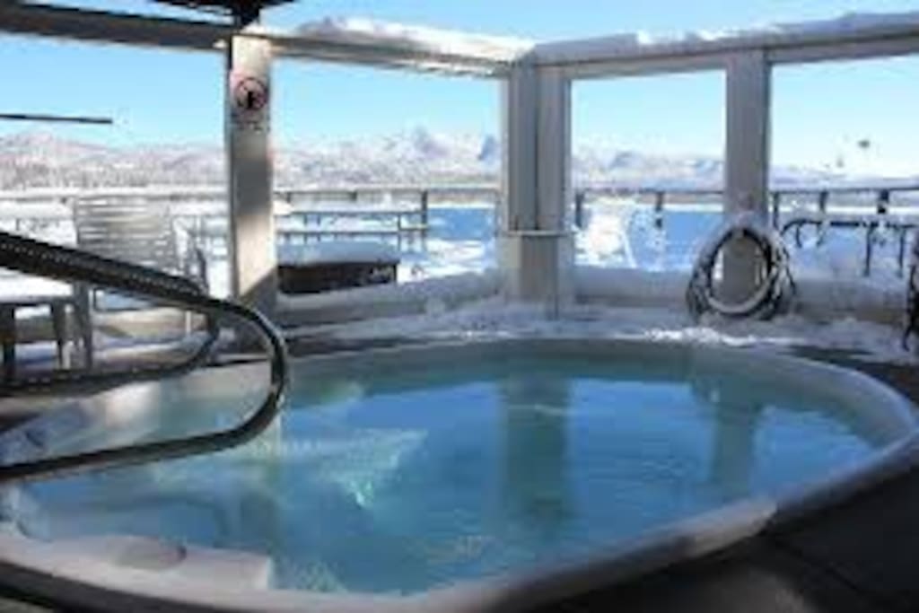 Heated outdoor spa with a views of the lake
