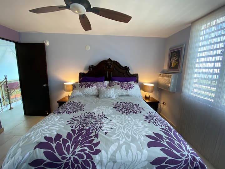 Queen size bed in a suite with private balcony