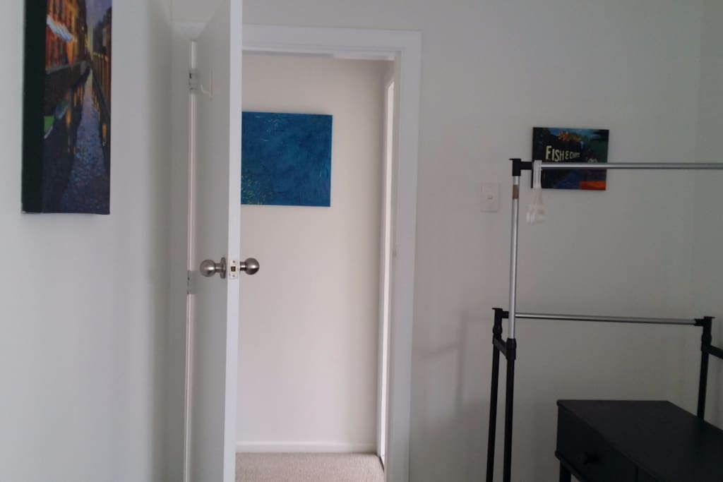 The bathroom is to the right through the door.