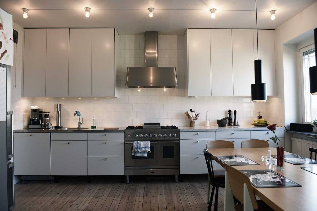 Large fully equipt kitchen with espresso machine, stove with two ovens, microwave oven and fridge/freezer.