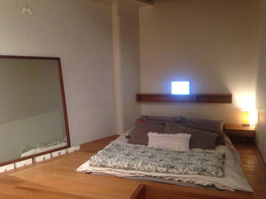 bedroom ~ sunken storage around bed ~ views to city
