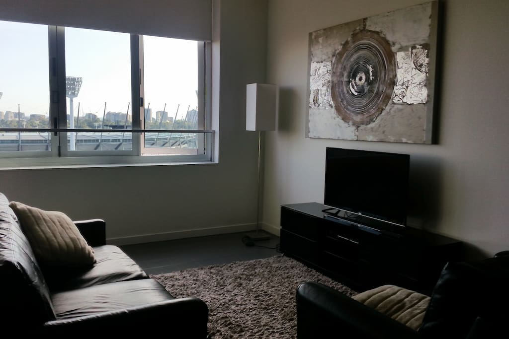 Comfortable lounge area adjacent to the kitchen. Fantastic views of the city from the comfort of the couch!