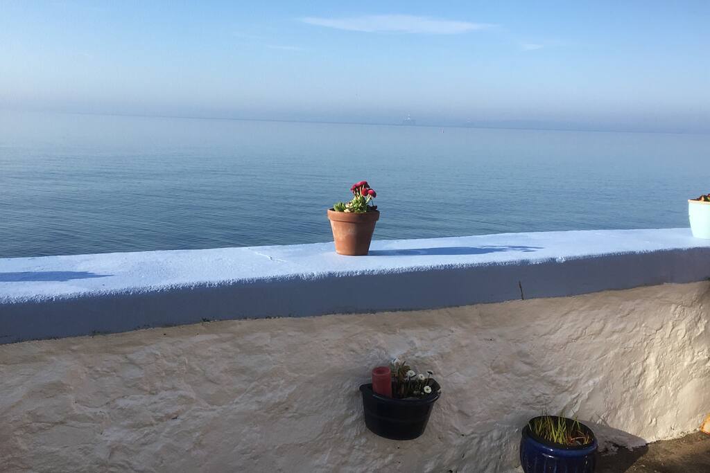 7:30am on a beautiful May morning in Rockpool courtyard looking out onto a calm ‘Mediterranean blue’ sea .