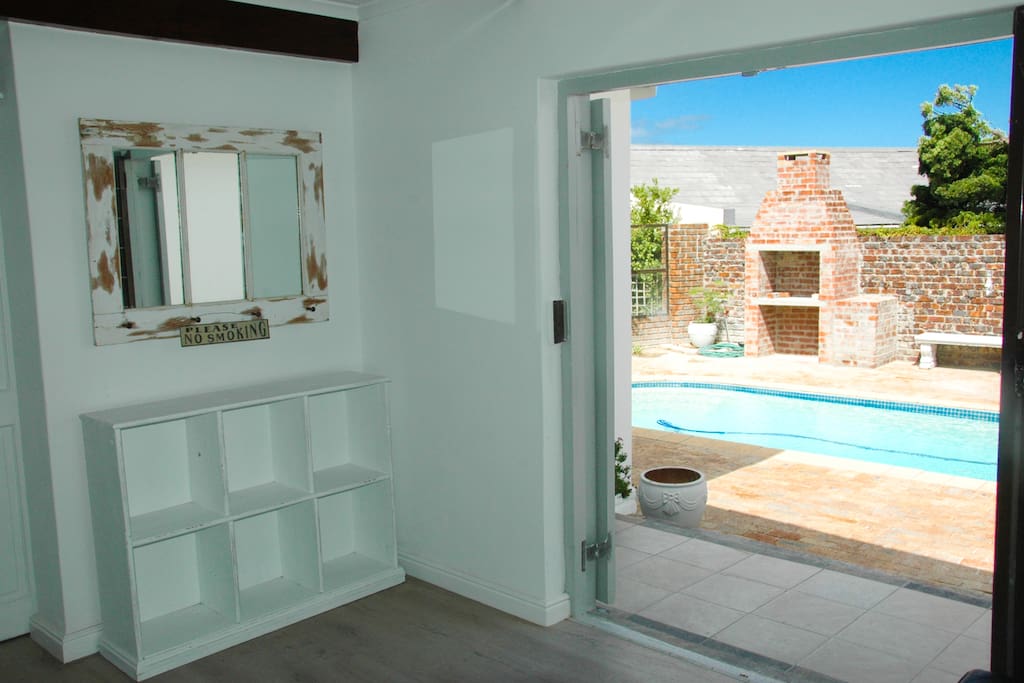 shoe stand along with rustic mirror with beautiful view of pool and bbq
