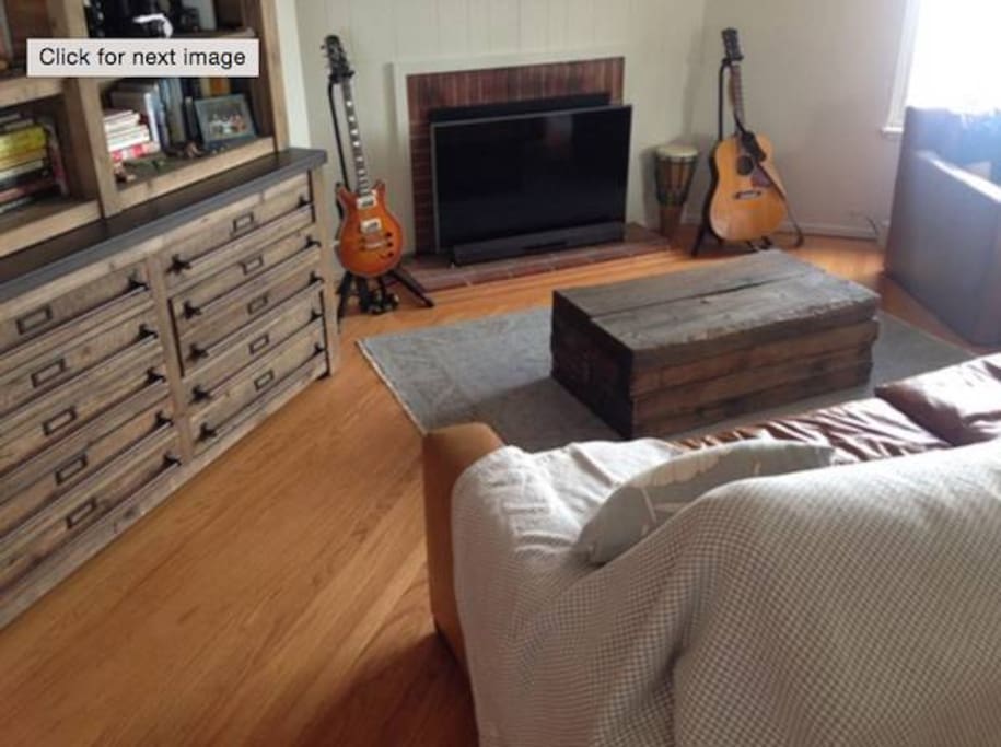 Living oom with LG Smart TV, modern rustic furniture, huge Restoration Hardware leather couch and chair