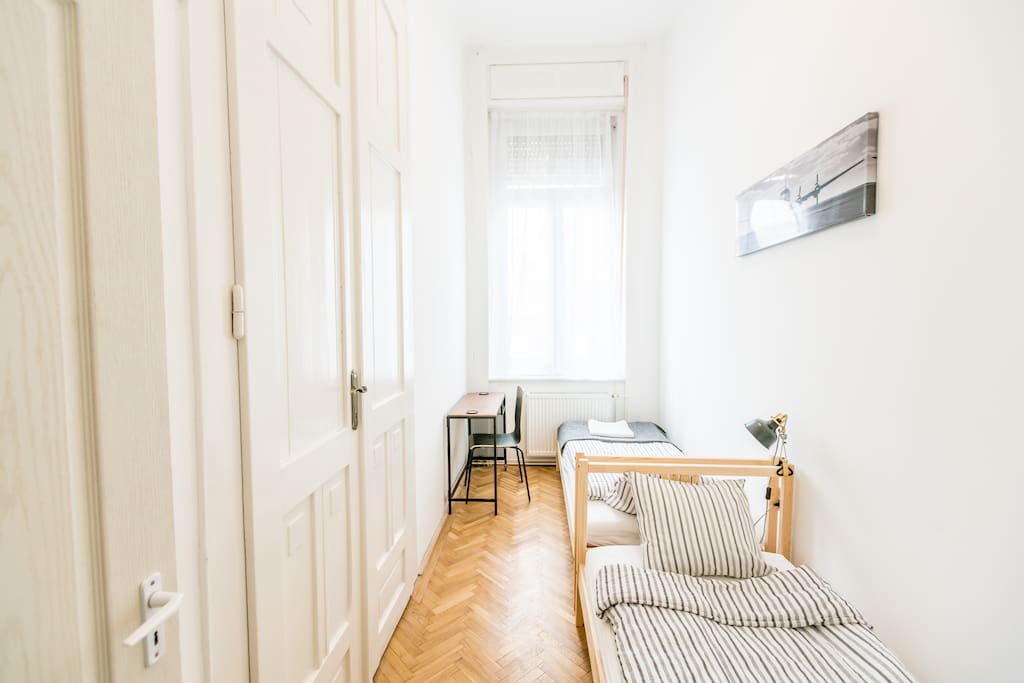 The bedroom in the middle with two single beds and a desk