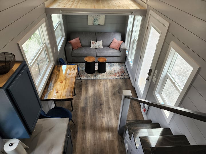 Enjoy a dining room with a custom made table (my husband Chad built it!) and a comfortable living space with storage footstools that house extra blankets and pillows, and can be utilized as end tables, and added seating.