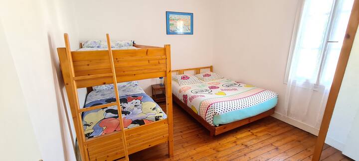 Kids bedroom with two bunk beds and a 140...... bed and comics and children's books in the wardrobe