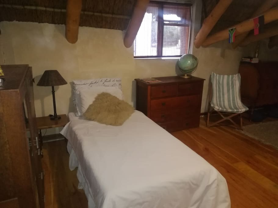 Clifford's Bedroom
Two single beds, thatch roof and wooden floors.
