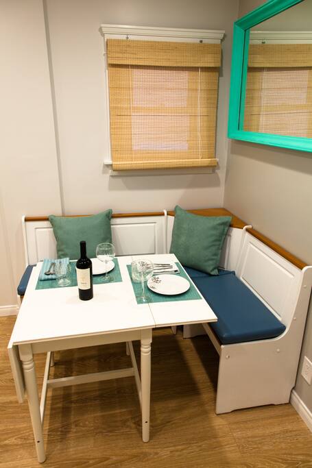 Dining area (or work space), with banquette and space-saving drop-leaf table.