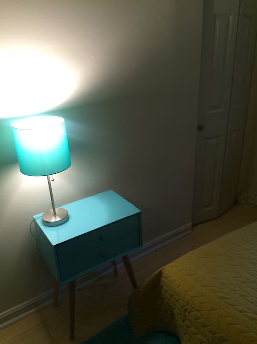 Lamp, nightstand and closet.