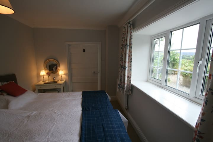 Downstairs KING SIZE DOUBLE  ( zip & link) or TWO  Single Beds 3 Feet 
view of Front Garden 