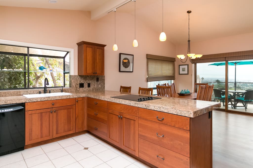 An open concept kitchen has lots of granite countertop space for keen chefs