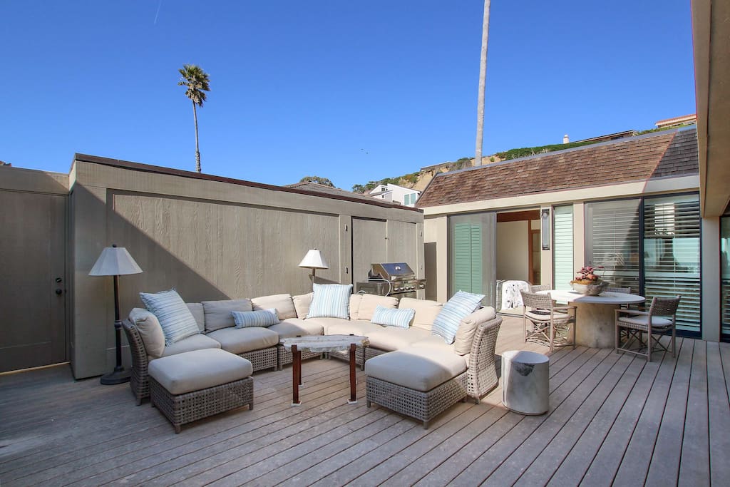 Private courtyard with outdoor living area, 4-person dining table, and a gas grill.