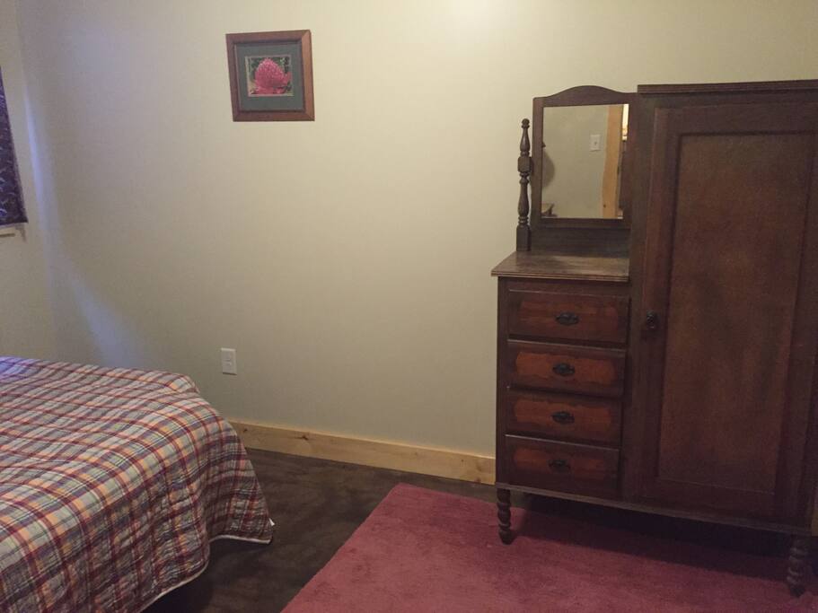 Separate bedroom with closet and drawers.