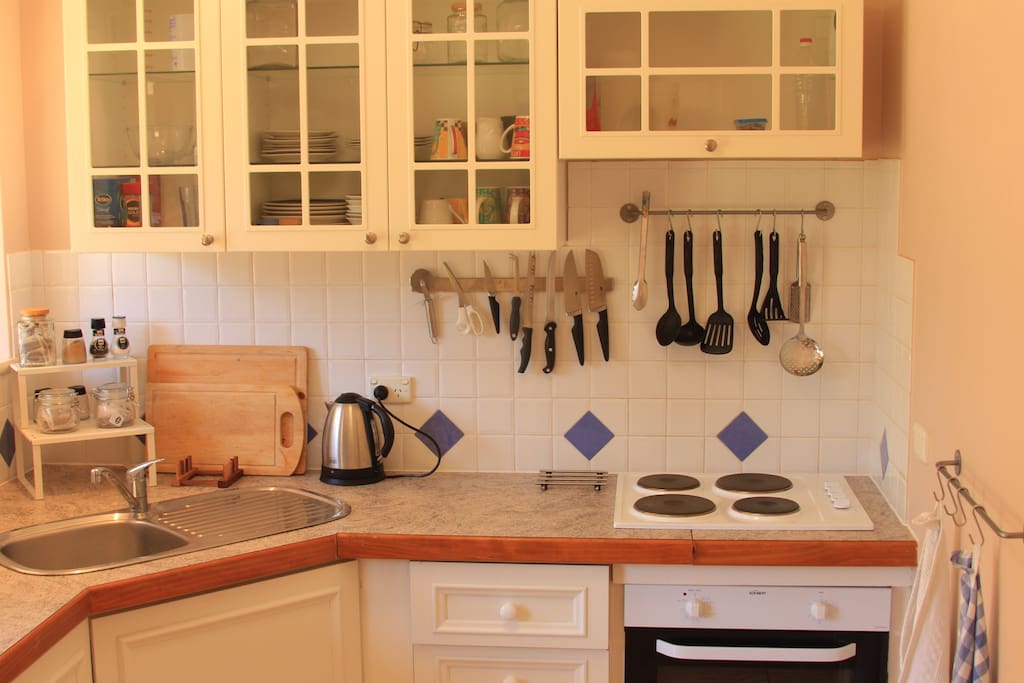 Fully equipped kitchen with electric oven and cook top.