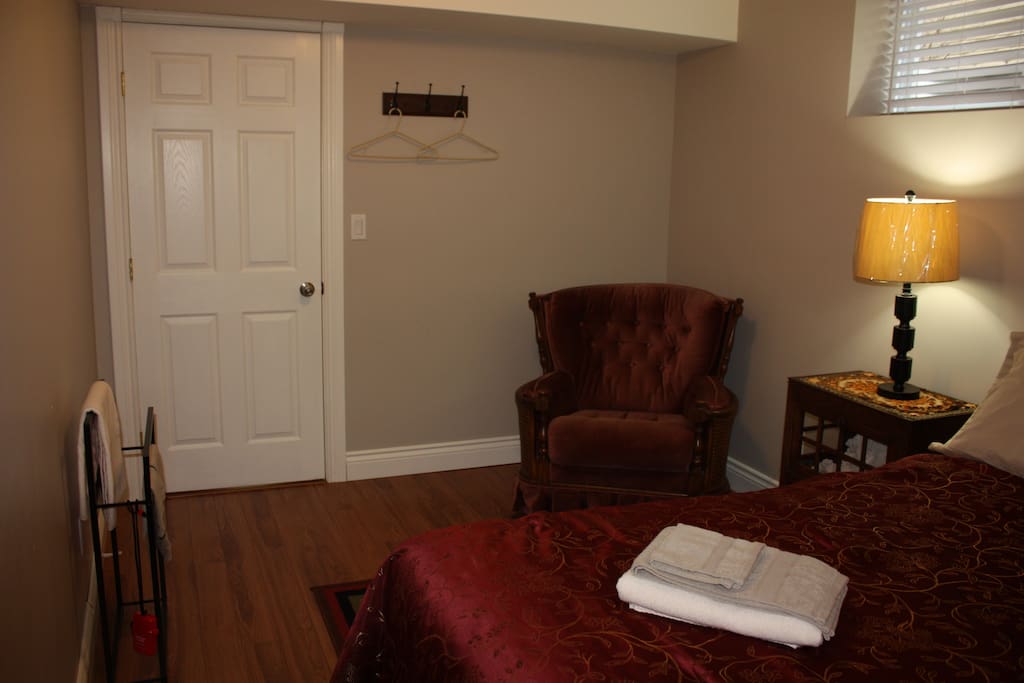 A comfy chair and personal towel rack.