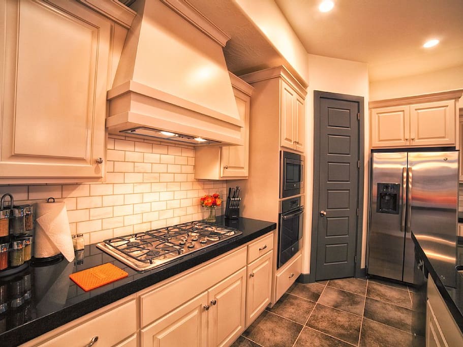 Kitchen includes stove, oven, utensils, appliances, dishwasher, toaster, microwave
