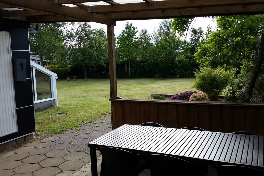 Closed terrace with garden view and table and chairs for 6 persons. There is also an open terrasse also with table and chairs for 6 persons.