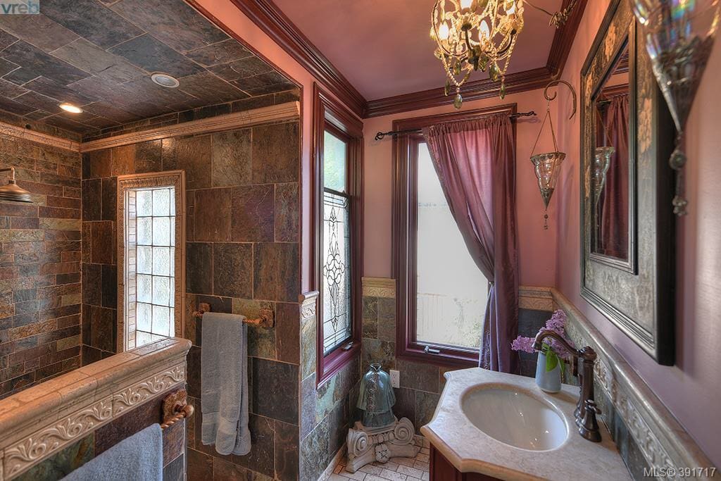 Beautiful slate and marble bathroom with rain head shower and heated floors.