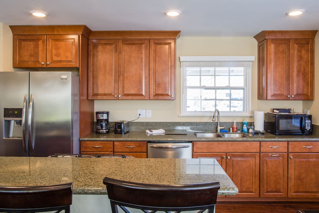 Fully equipped kitchen with granite counter tops, microwave, coffeemaker, toaster and all the dinnerware and utensils you need