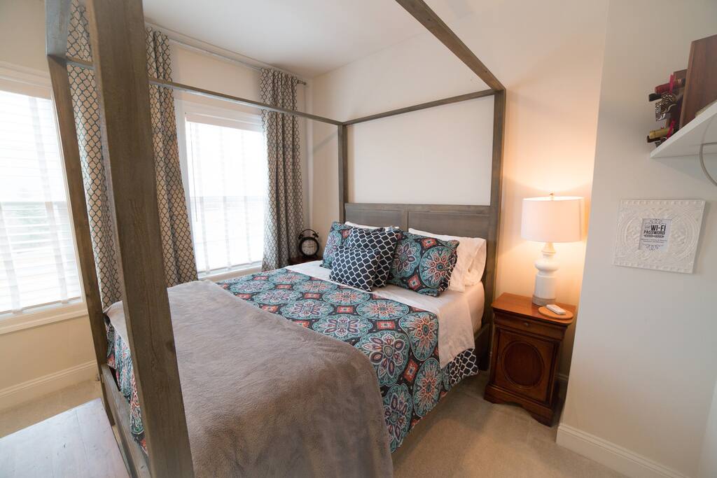 Queen-sized canopy bed with memory foam mattress.