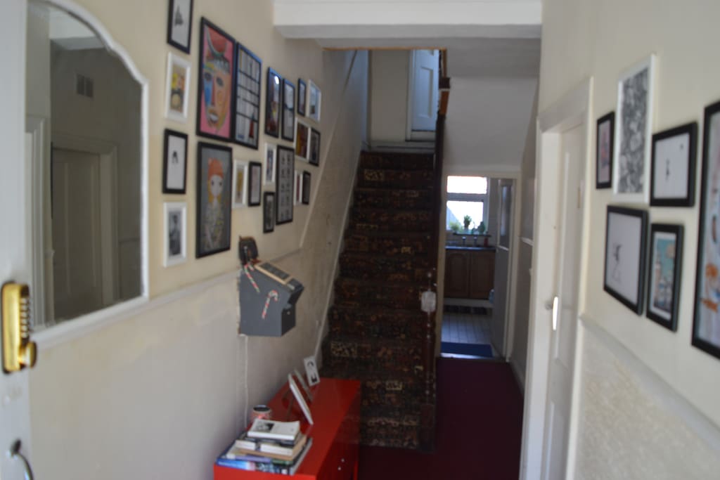 Quirky entrance hallway to house has funky art work thoughout