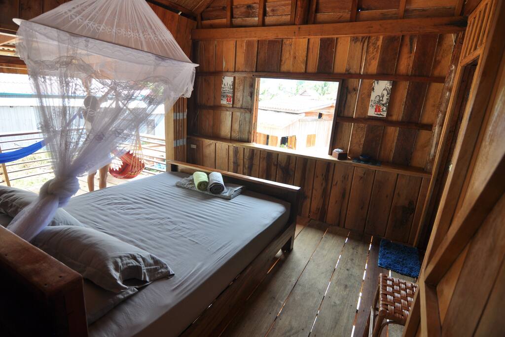 A cosy room with new comfy bed and ceiling fan.