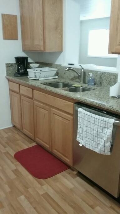 There is a coffee maker. Coffee, filters, and creamer and sugar are provided.
