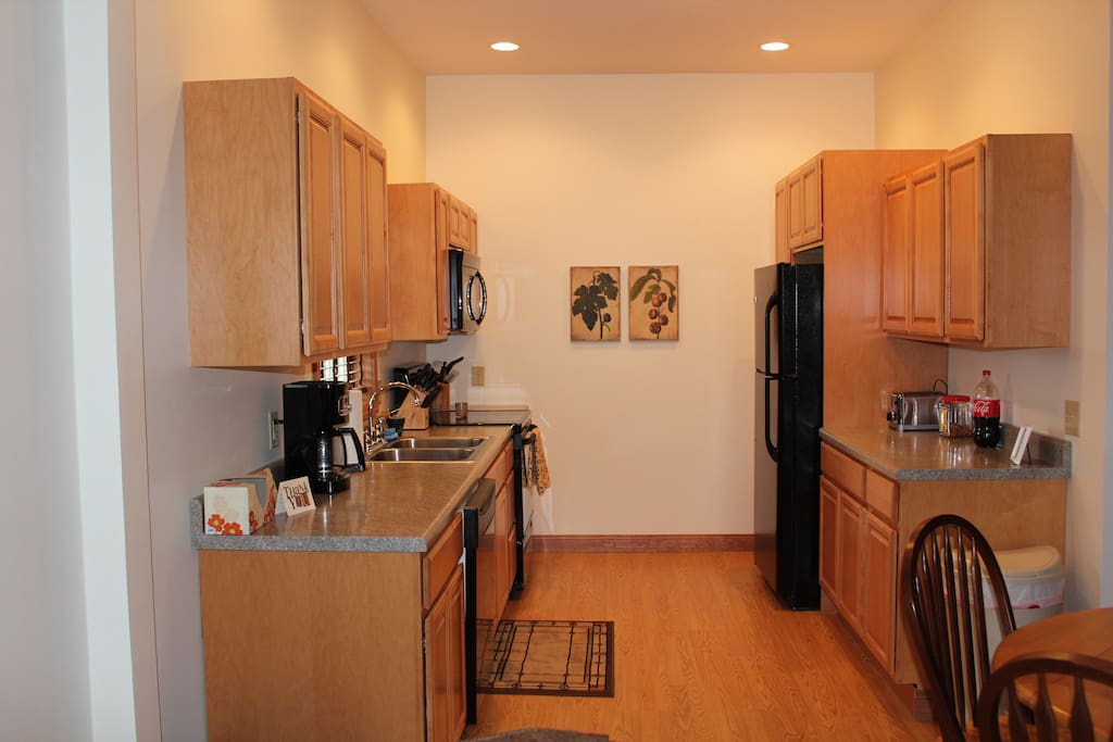 Kitchen with electric range, microwave, dishwasher and refrigerator