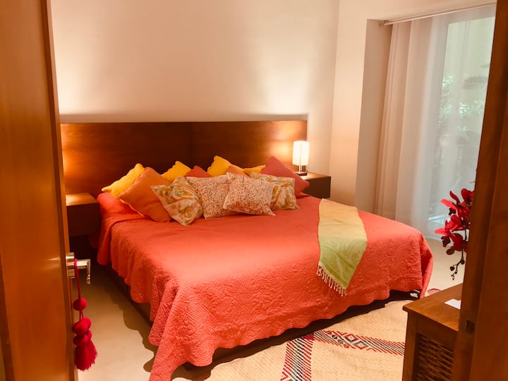 Bedroom with king size bed, two table lamps with usb connection for phones . Picture taken from entry door