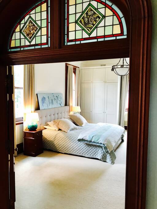 bedroom 1. king size bed in a massive room (6.7m x 4.9m) with beautiful ornate ceilings, large robes, Aircon and walk through into main bathroom.