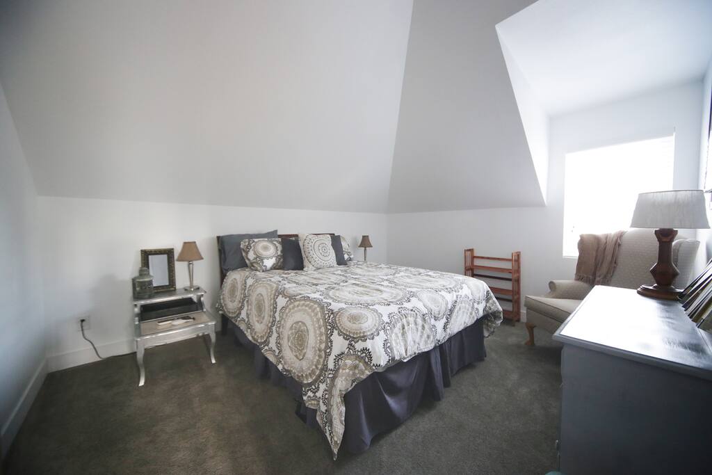 Bedroom with walk in closet, queen sized bed.