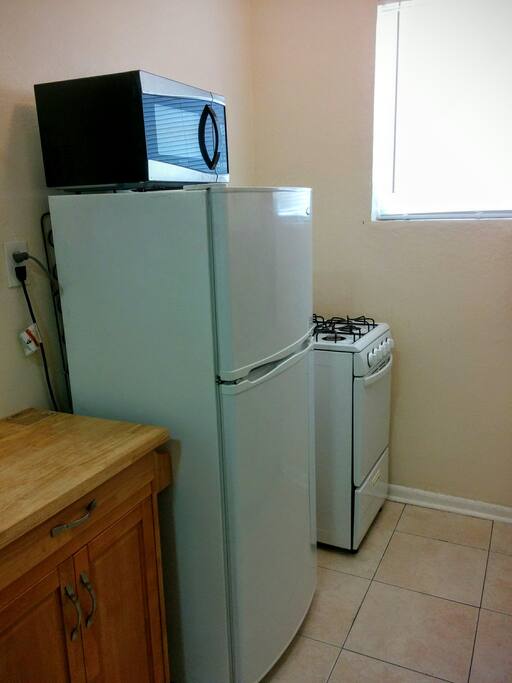 Full Size refrigerator, oven and stove. Cooking island.