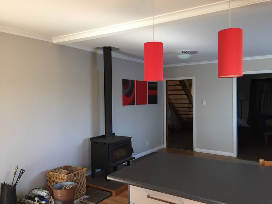 Open plan kitchen, dining and lounge heated by wood burner.