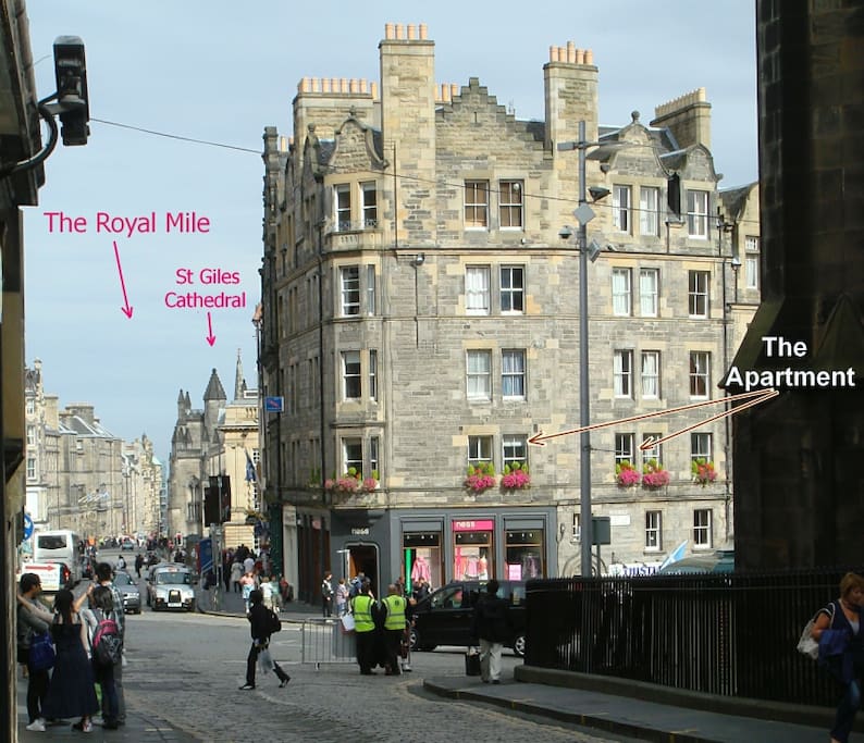 The windows of the apartment. To the left, the view down the Royal Mile