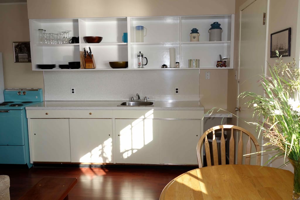 With an equipped galley style kitchen and the funkiest turquoise 1960s stove, you will ever see