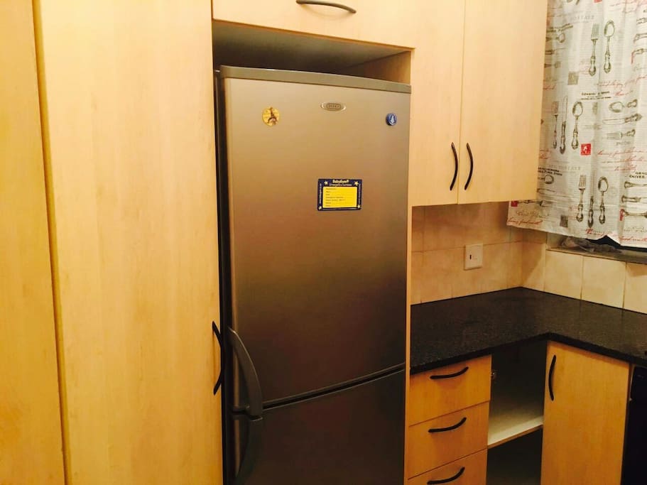 Fitted kitchen with a seperate fridge.